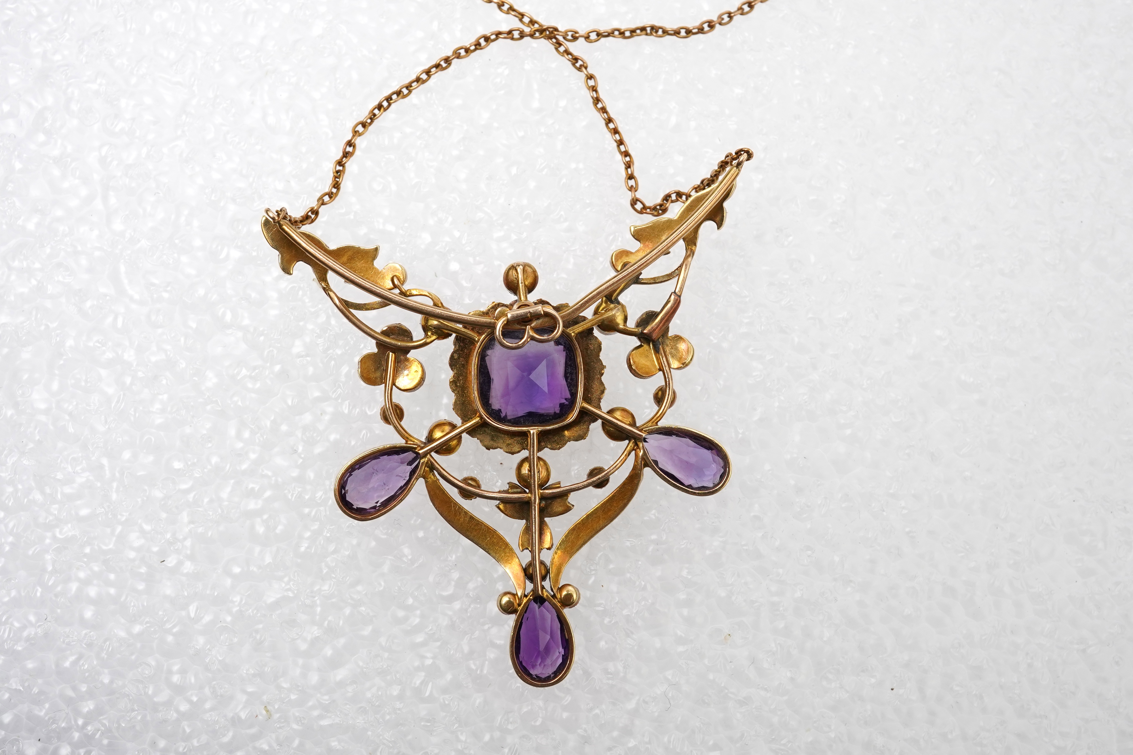 An Edwardian seed pearl and amethyst pendant/brooch, early 20th century